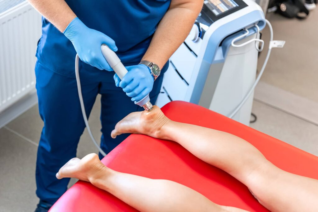 Patient receiving shock wave treatment for plantar fasciitis on their left foot