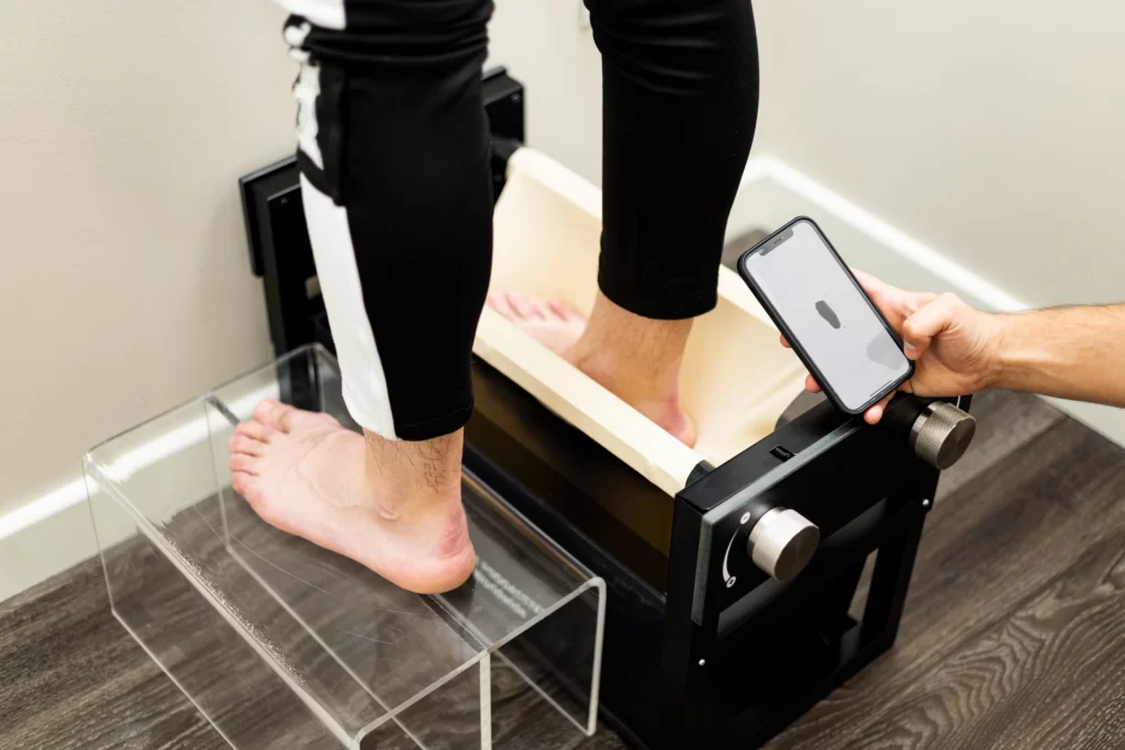 Man standing with one foot in a 3D scanner and doctor holding phone