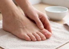 Close-up of a person inspecting a toe with an ingrown nail, illustrating will an ingrown toenail heal itself.