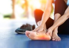 Foot of woman runner with plantar fasciitis pain